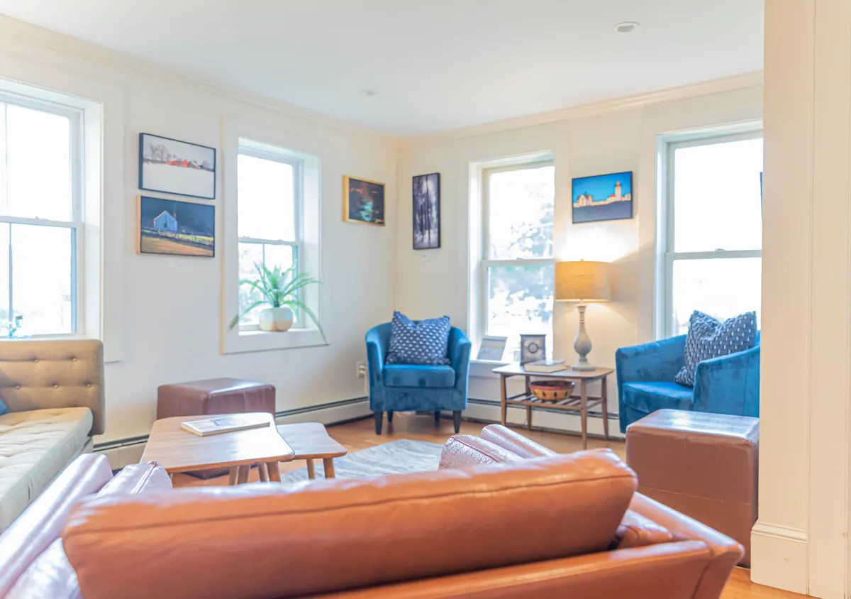 The bakery’s bright front room with blue armchairs, a sofa and local artwork