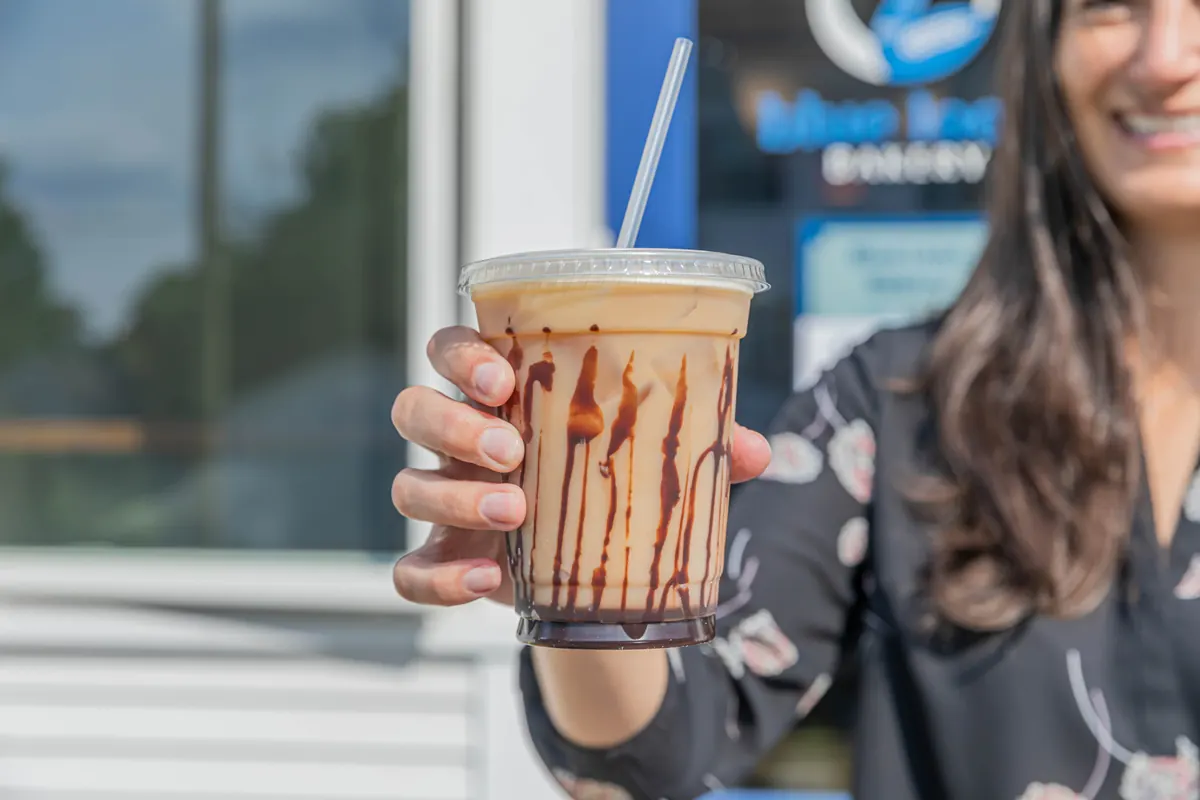 An iced mocha held up by the bakery’s front window