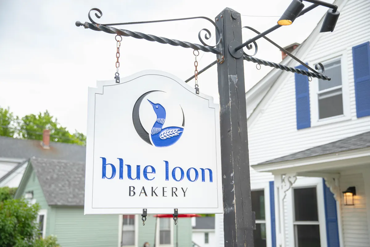 The Blue Loon Bakery hanging sign on the street
